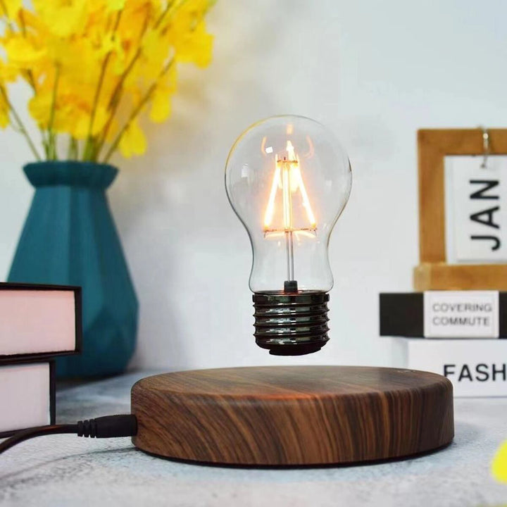 The lamp on a side table next to a vase