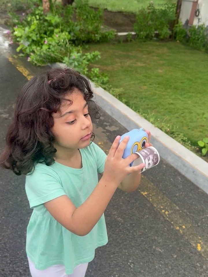 Small hands holding the camera